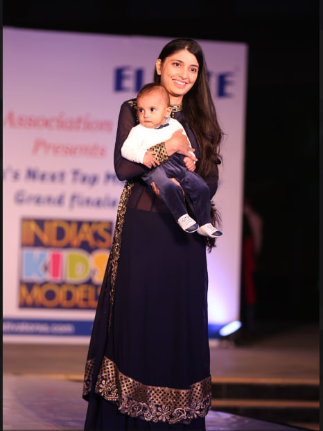 Mother holding baby on runway